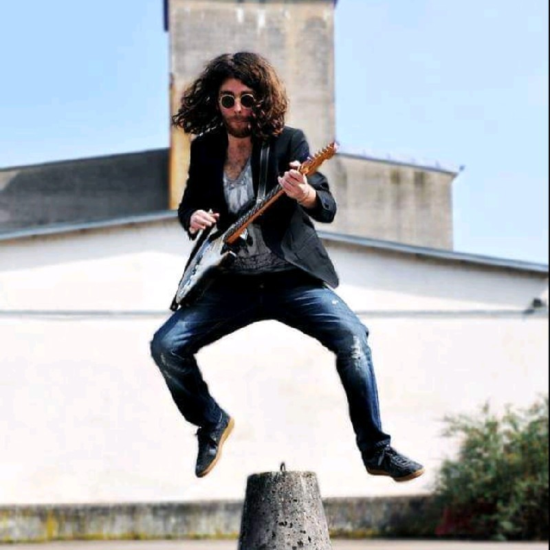 Man jumping with a guitar